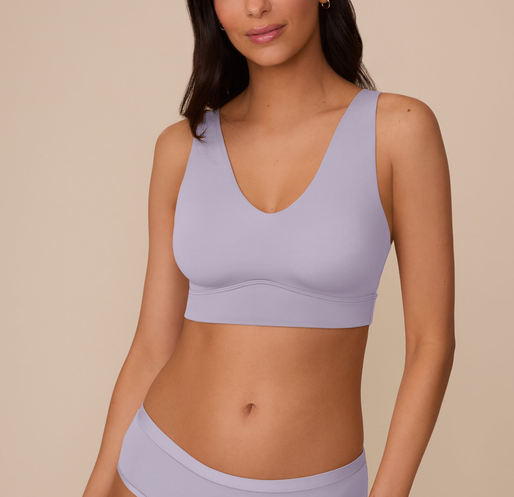 Marcela models the Bliss Bralette in Violet with the Bliss Hiphugger in Violet, shown from the front. The bralette features a v-shaped scoop neckline with wide, smoothing straps and a seamless silhouette. The hiphugger sits low on the waist for a minimal, comfortable look. sizing: Marcela wears size Small