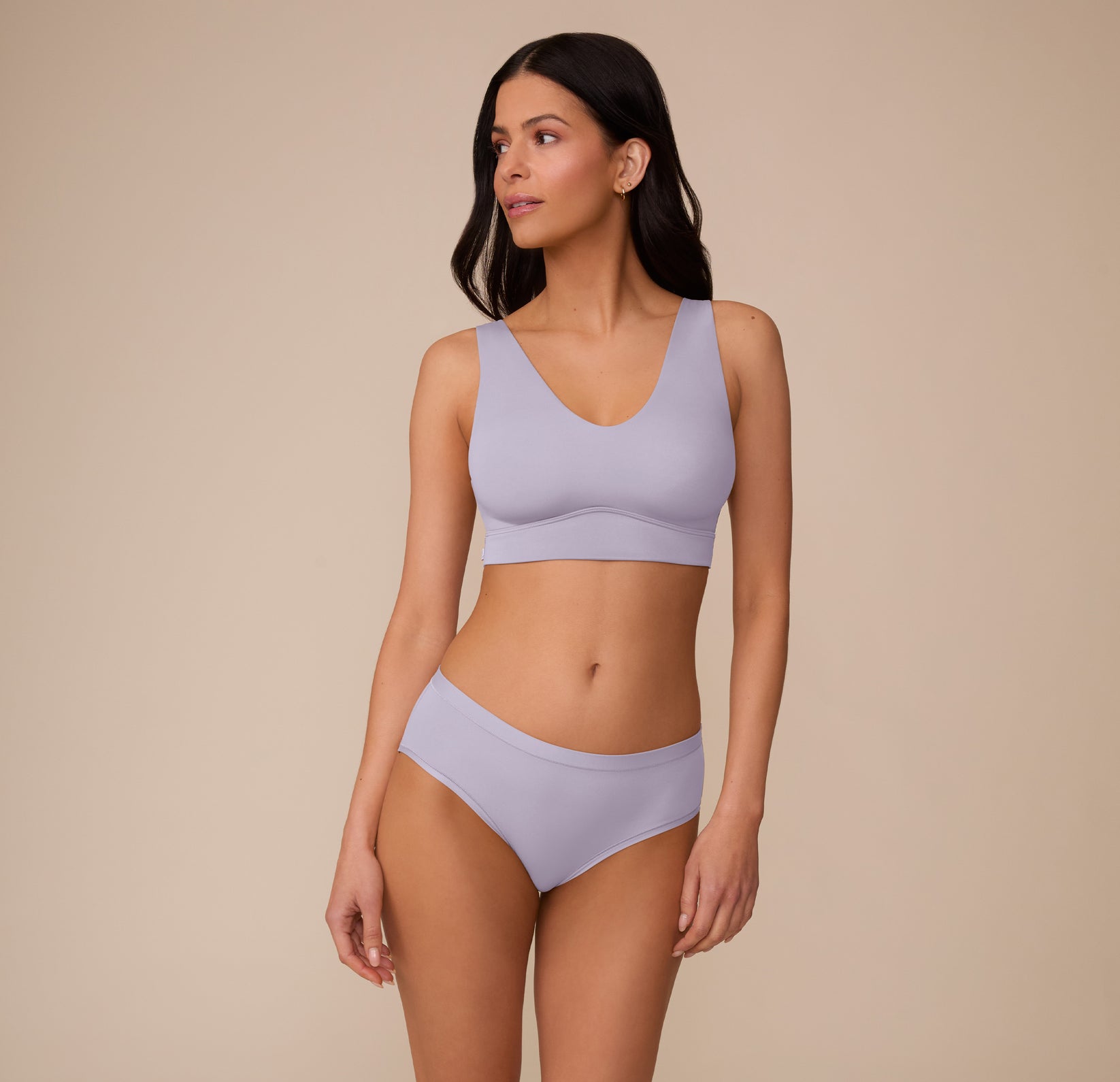 Marcela poses in a relaxed front-facing stance in the Bliss Bralette in Violet and Bliss Hiphugger in Violet, showcasing the coordinated seamless look and flattering, full-coverage design in the soft Violet color.