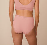 Back view of Freya in the Bliss Highwaist Brief in Dusty Rose, showing the smooth, full-coverage fit and wide waistband.