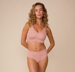 Full body shot of Freya wearing the Bliss Highwaist Brief and matching Bliss Bralette in Dusty Rose. The set emphasizes comfort-first design with a smoothing, stay-in-place fit.