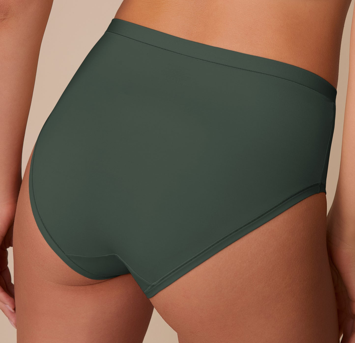 Close-up of the Bliss Highwaist Brief in Fir on Alexis, highlighting the soft stretch fabric and clean finish.