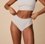 Close-up front view of Ally wearing the Bliss Highwaist Brief in Frost. The image highlights the mid-rise waistband and smooth, full-coverage fit made from ultra-soft, breathable fabric. sizing: Ally wears size Small