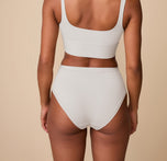 Back view of Ally in the Bliss Highwaist Brief in Frost. The image showcases the seamless back coverage and flattering leg openings that offer comfort without digging.