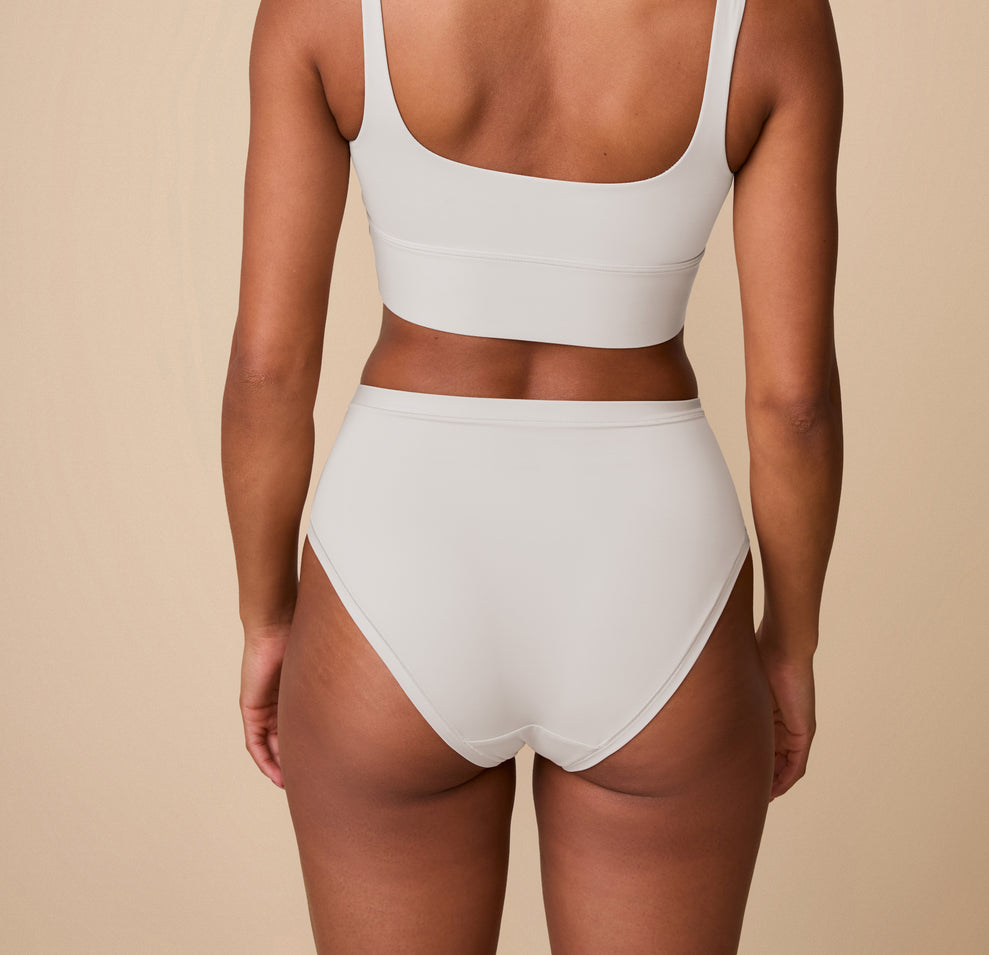 Back view of Ally in the Bliss Highwaist Brief in Frost. The image showcases the seamless back coverage and flattering leg openings that offer comfort without digging.