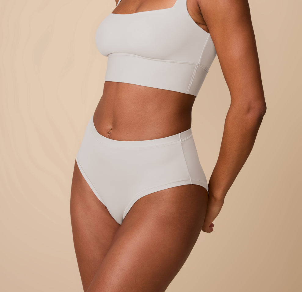 Side angle of Ally in the Bliss Highwaist Brief in Frost. This view emphasizes the clean stitching and soft, flexible waistband.