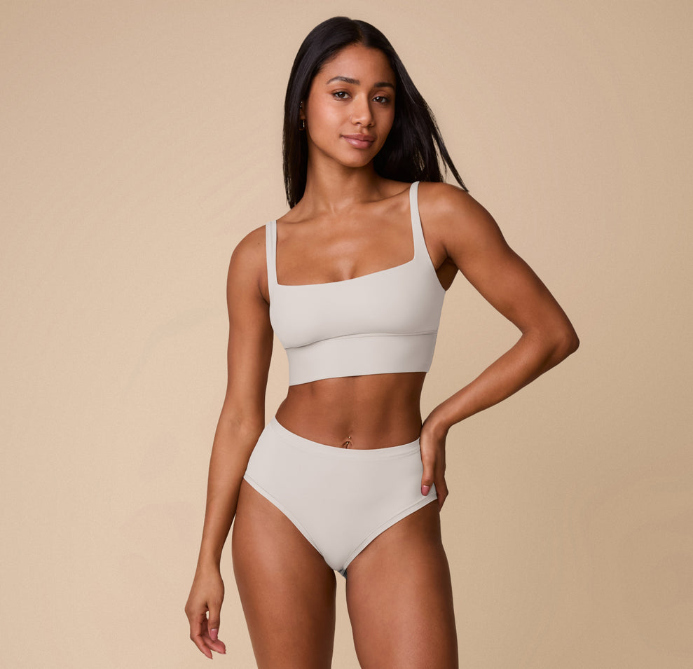 Full-body shot of Ally wearing the Bliss Highwaist Brief and coordinating Bliss Square Neck Bralette in Frost. The set highlights the minimal, elevated design and barely-there feel.