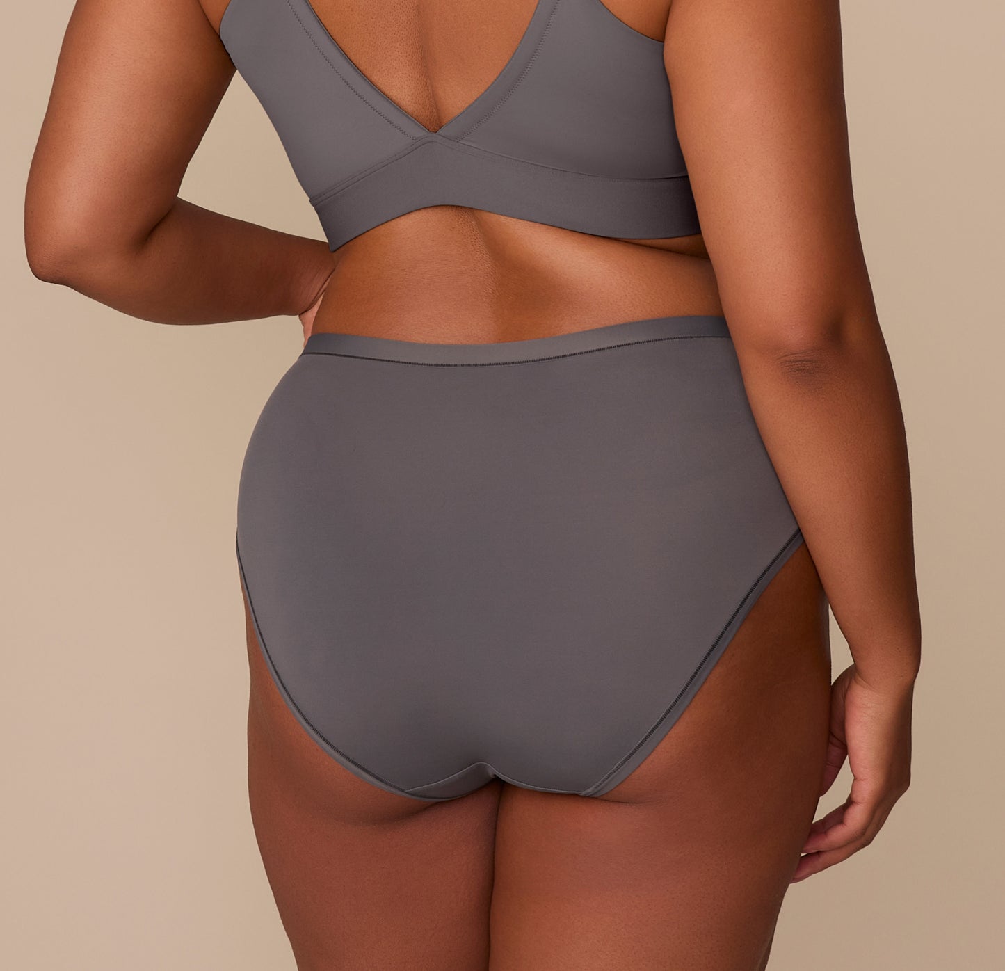 Back view of Zarria in the Bliss Highwaist Brief in Smoke, highlighting the minimal seam look and ultra-soft microfiber fabric with a tagless waistband.