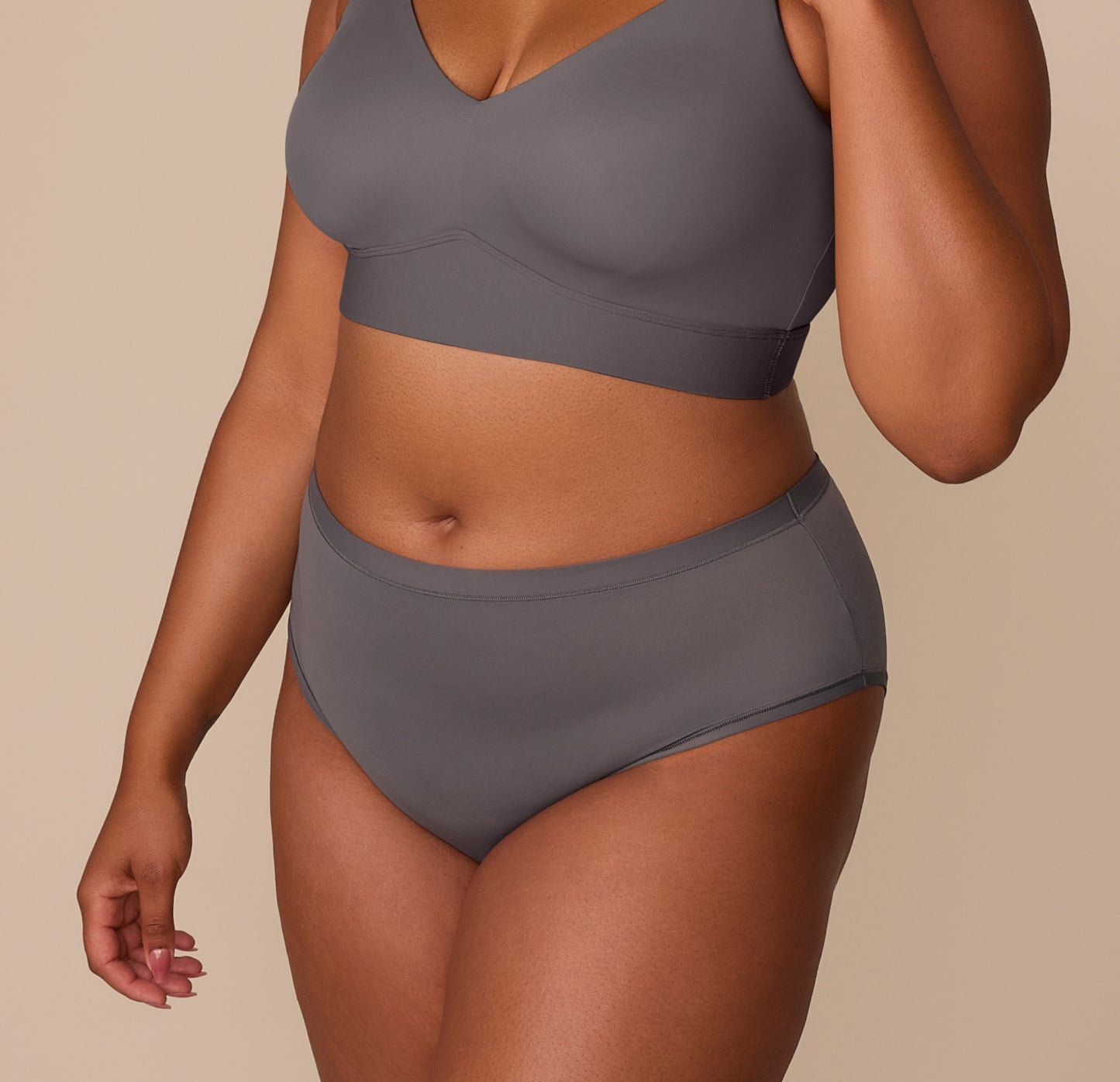 Side view of Zarria in the Bliss Highwaist Brief in Smoke, showing the gentle leg openings and flexible stretch for all-day comfort.