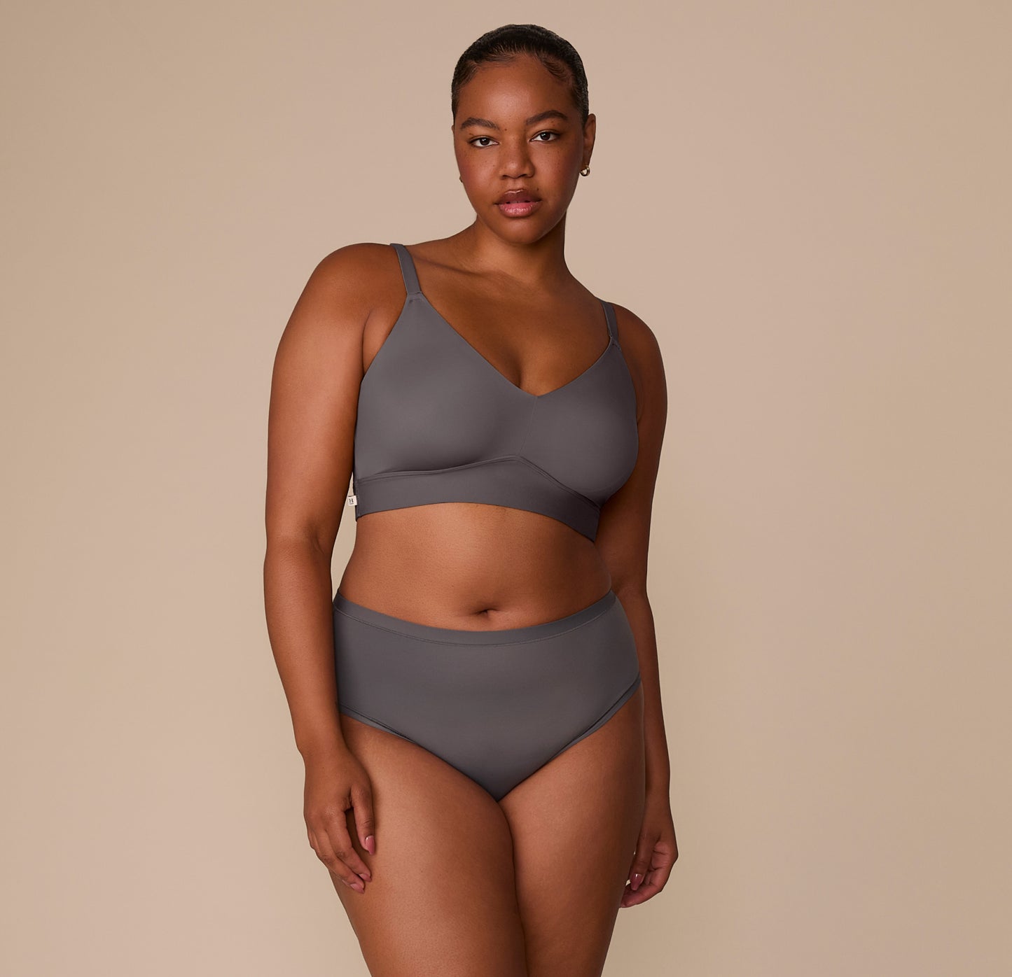 Full body front-facing image of Zarria wearing the Bliss Highwaist Brief and coordinating Bliss Triangle Bralette in Smoke. The image showcases the effortless comfort and sleek, supportive style of the set.