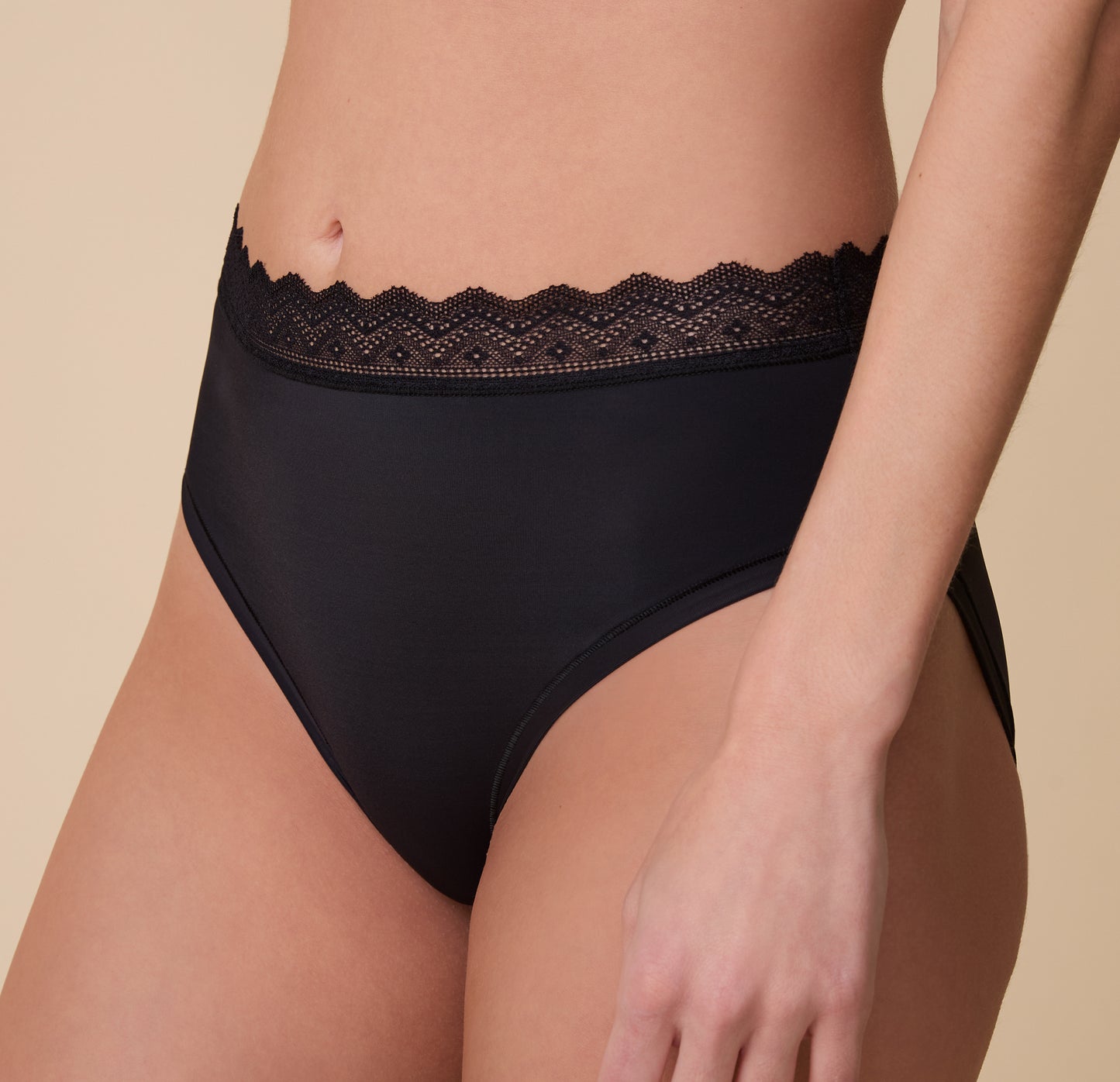 Close-up of the Bliss Lace Highwaist Brief in Black on Gracie, showcasing the intricate lace waistband and smooth, stretchy fabric for a barely-there feel.