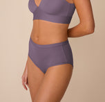 Side profile of Freya wearing the Bliss Highwaist Brief in Eclipse with the Bliss Triangle Bralette in Eclipse. The brief’s soft stretch and flattering fit are shown in profile alongside the contoured silhouette of the bralette.