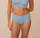 Front view of Freya wearing the Bliss Highwaist Brief in Glacier. The soft blue brief sits comfortably at the waist, offering full coverage and a minimal seam finish under clothing. sizing: Freya wears size Small