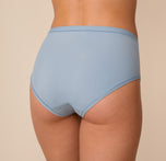 Close-up back angle of Freya in the Bliss Highwaist Brief in Glacier. The smooth, microfiber fabric hugs her curves without digging or riding up.