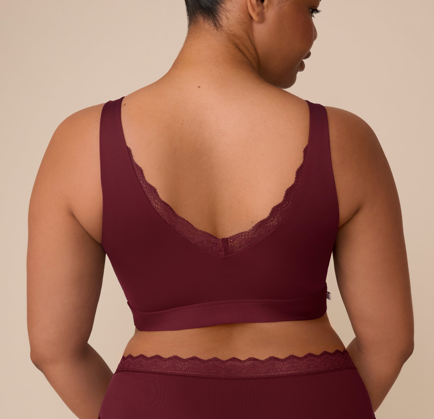 Rear view of the Bliss Lace Bralette in Bordeaux on Zarria, featuring a deep V-back design with matching lace trim along the neckline.
