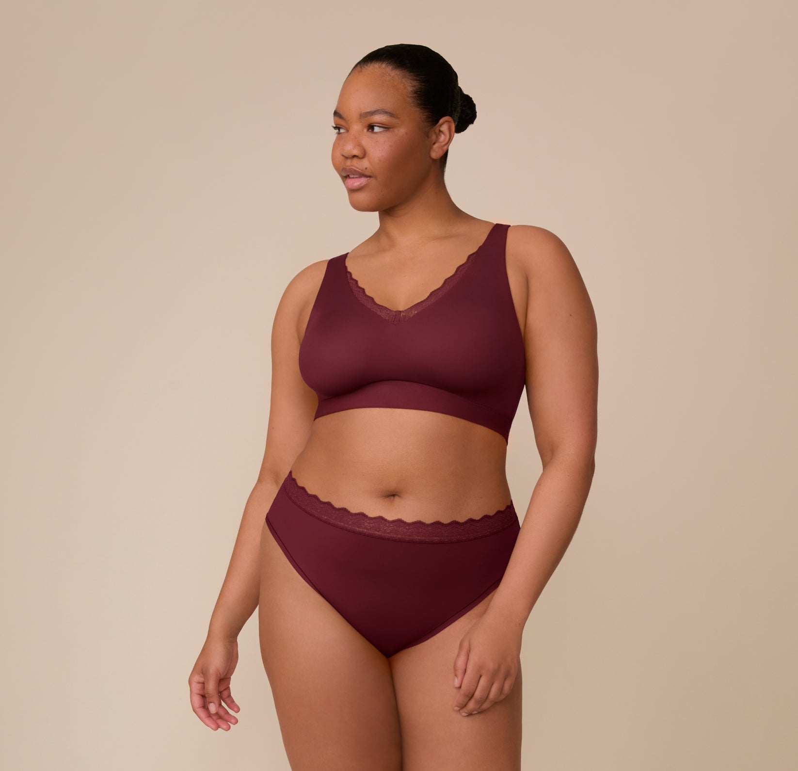 Zarria models the Bliss Lace Bralette and Bliss Lace Highwaist Brief in Bordeaux. The image emphasizes the coordinated lace trim and smooth, supportive fit.