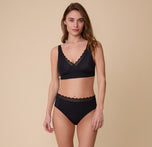 Gracie poses in the Bliss Lace Bralette in Black with the matching Bliss Lace Highwaist Brief. The image highlights the full set, emphasizing comfort and everyday wearability.