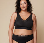 Bianca models the Bliss Lace Bralette in Black, highlighting its supportive yet flexible fit with lace detailing. sizing: Bianca wears size XL