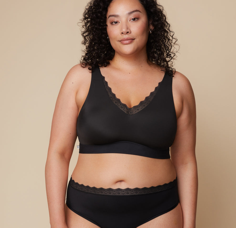 Bianca models the Bliss Lace Bralette in Black, highlighting its supportive yet flexible fit with lace detailing. sizing: Bianca wears size XL