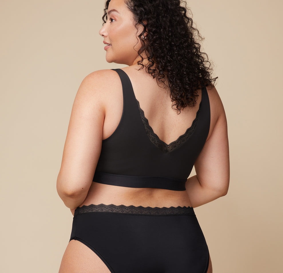 A rear view of Bianca in the Bliss Lace Bralette in Black, showing the lace-trimmed V-back and wide straps for a comfortable fit.