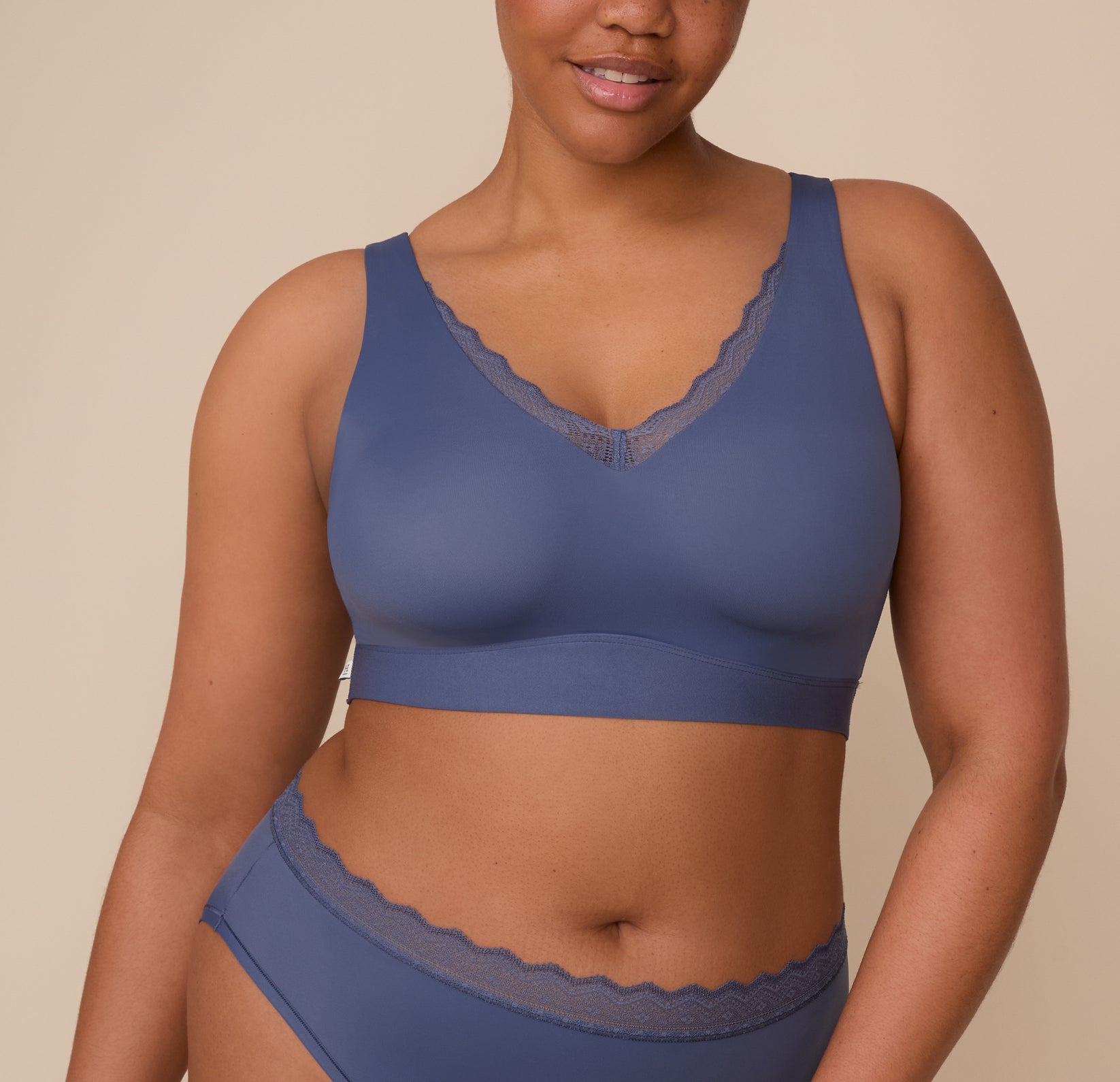 Zarria wearing the Bliss Lace Bralette in Twilight, front view. A close-up shot showcasing the deep V-neckline trimmed with soft lace and the smooth, wirefree design offering full coverage and comfort. sizing: Zarria wears size XL