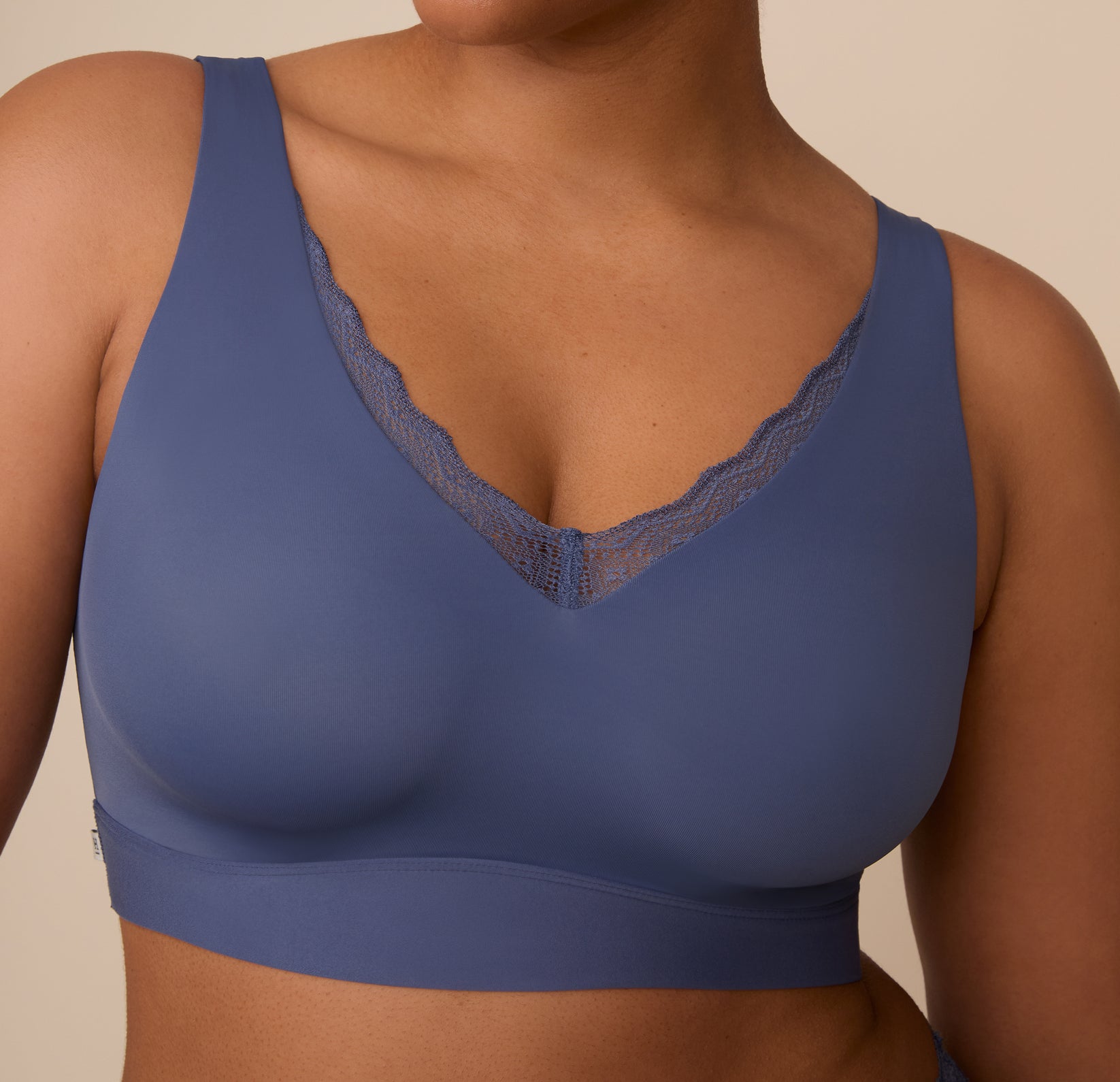 Close-up of the lace neckline on the Bliss Lace Bralette in Twilight. The scalloped lace adds a feminine touch to the bralette’s sleek, seamless silhouette.