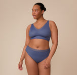Zarria in a full-body shot wearing the Bliss Lace Bralette and Bliss Lace Highwaist Brief in Twilight. The coordinated set emphasizes comfort and style, with smooth stretch fabric and delicate lace trim around the waistband and neckline.