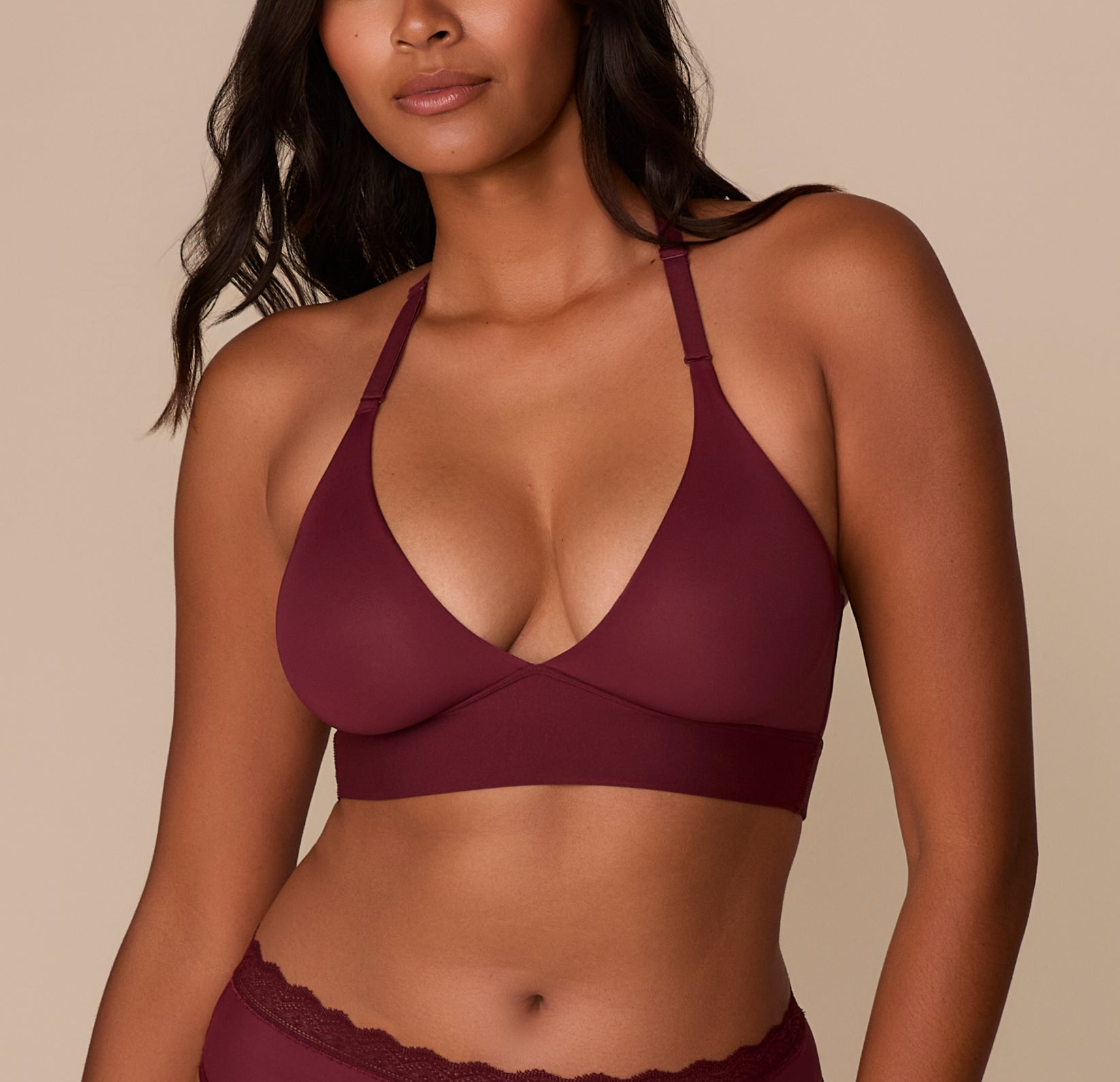 Close-up of Victoria wearing the Bliss Lace Halterneck Bralette in Bordeaux. The image highlights the deep V-neckline, molded cups, and front-adjusting halter straps. sizing: Victoria wears size Medium