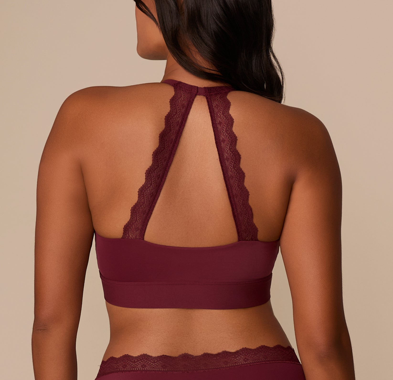 Rear view of the Bliss Lace Halterneck Bralette in Bordeaux on Victoria, showing the soft lace halter straps that meet at the neckline for a racerback look.