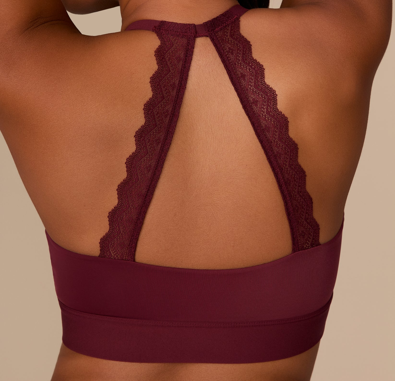 Detailed shot of the back lace halter straps on the Bliss Lace Halterneck Bralette in Bordeaux, showing the scalloped edge and stretch comfort.