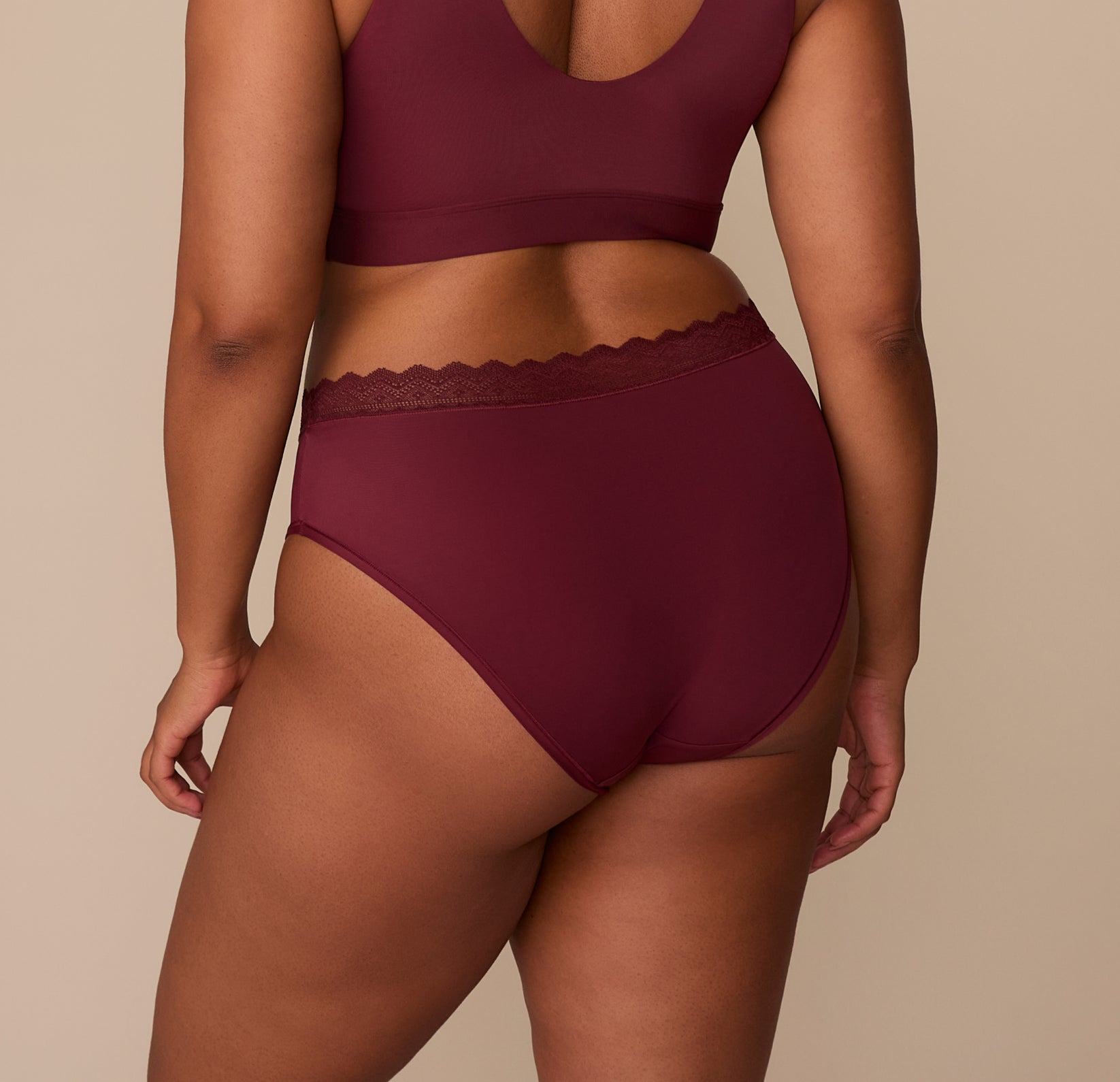 Rear view of Zarria in the Bliss Lace Highwaist Brief in Bordeaux. The brief cut offers full coverage with soft, stretch fabric for a stay-put fit.