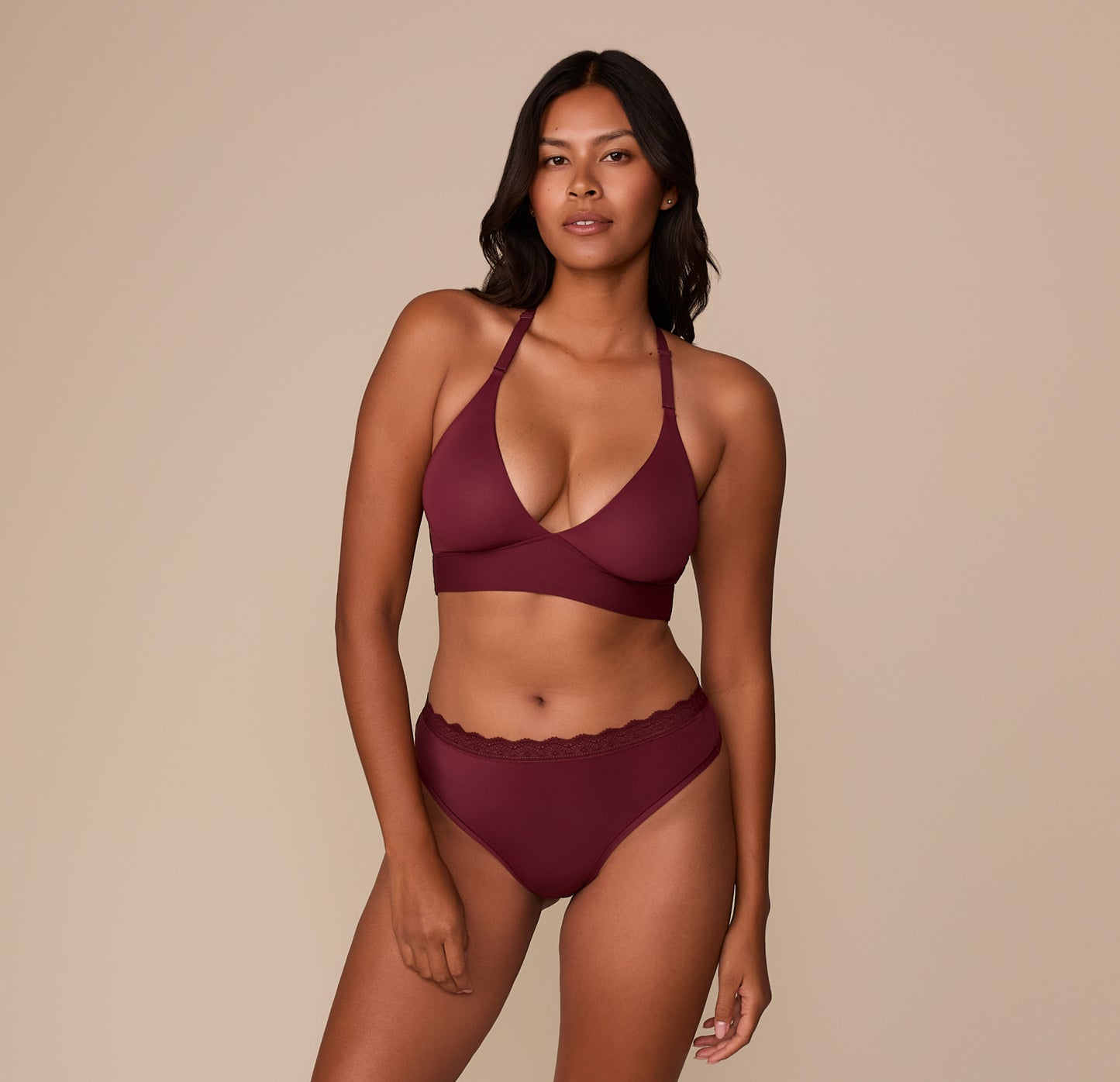 Victoria models the Bliss Lace Highwaist Thong and matching Bliss Lace Halterneck Bralette in Bordeaux. The coordinated set features soft lace trim and Harper Wilde’s signature ultra-soft fabric.