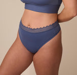 Three quarter profile of Sonnie in the Bliss Lace Highwaist Thong in Twilight. The seamless fabric and lace waistband hug the waist gently while maintaining a sleek, modern silhouette.