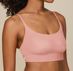 Close-up of Zoe’s upper body in the Bliss Scoop Bralette in Dusty Rose, showing the comfy fit of the bralette’s straps and fabric against her skin.