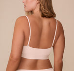 Rear view of Sonnie in the Bliss Scoop Bralette in Rose, showcasing the smooth back band and thin adjustable straps.