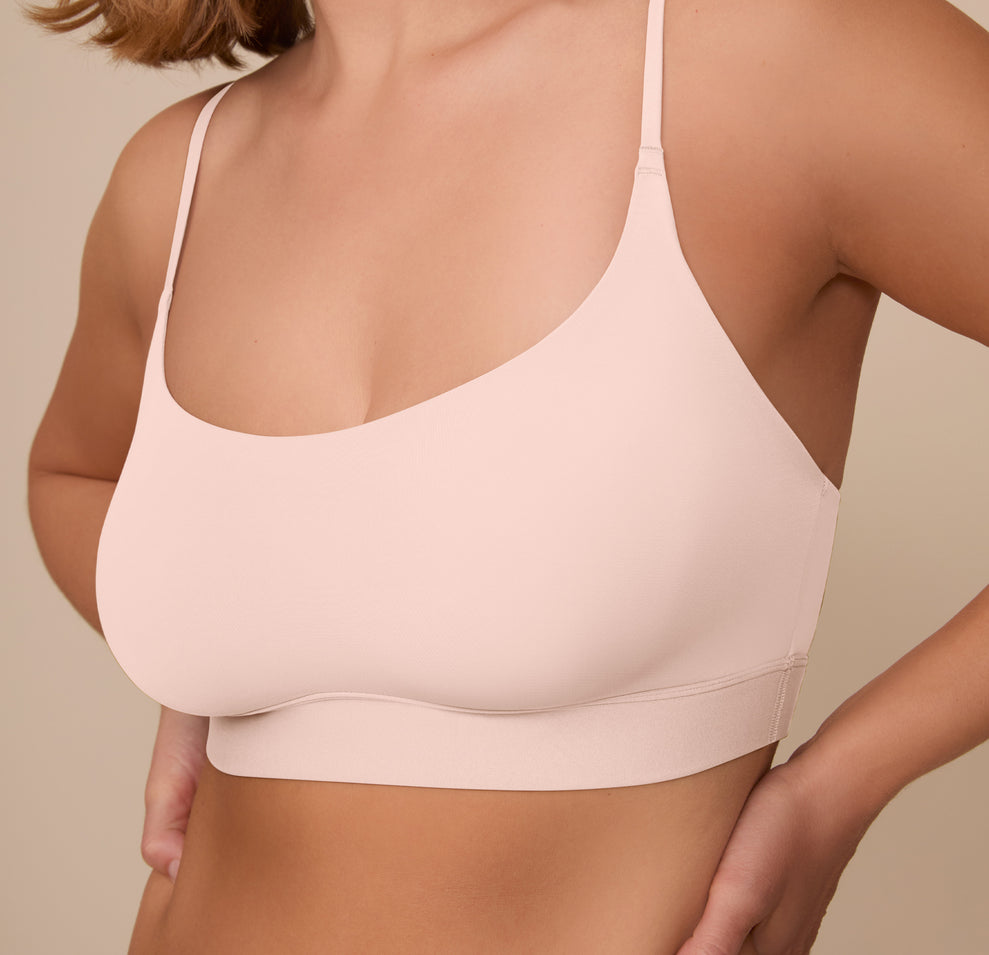 Close-up of the front of the Bliss Scoop Bralette in Rose worn by Sonnie. The image focuses on the smooth finish, scoop neckline, and supportive band.