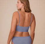 Rear view of Sonnie in the Bliss Scoop Bralette in Steel, showcasing the smooth back band and thin adjustable straps.