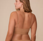 Back view of Sonnie in the Bliss Scoop Bralette in Tan, highlighting the streamlined design and barely-there back coverage.
