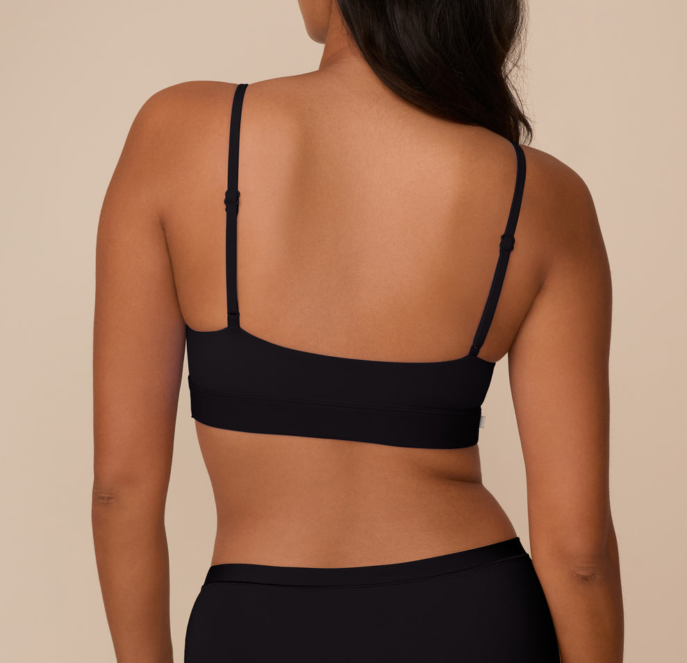 Rear view of Victoria wearing the Bliss Scoop Bralette in Black, showing the smooth back band and adjustable straps.