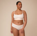 Zarria wears the Bliss Scoop Bralette with the Cloud Cotton Hiphugger Brief in Quartz. The full look emphasizes the set’s comfort-first design and flattering, barely-there feel.