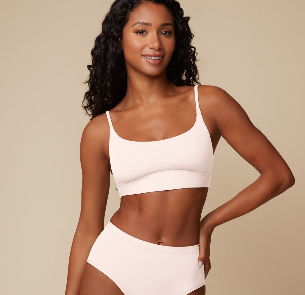 Ally models the Bliss Scoop Bralette in Quartz. The image shows the bralette’s gentle contouring, buttery-soft texture, and secure underband fit. sizing: Ally wears size Small