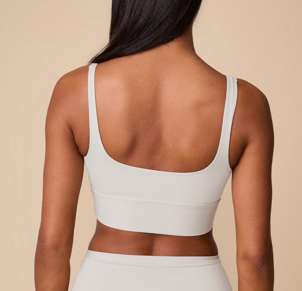 Back view of Ally in the Bliss Square Neck Bralette in Frost. The image shows the scoop-back design and wide band, showcasing the smooth, tagless fit of the bralette.