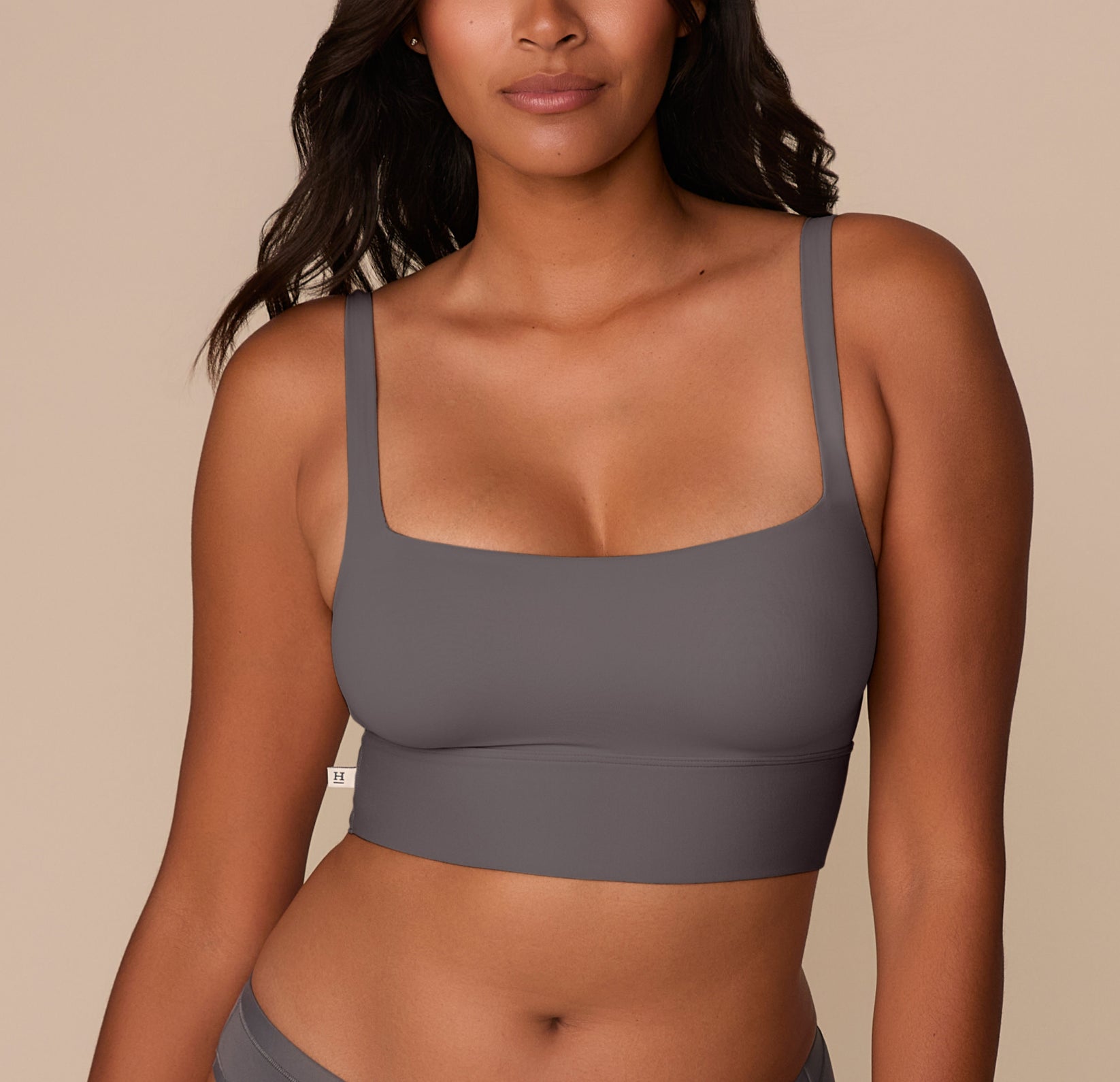 Victoria wearing the Bliss Square Neck Bralette in Smoke. The front view highlights the bralette’s clean square neckline and wide underband for gentle, wire-free support. sizing: Victoria wears size Medium