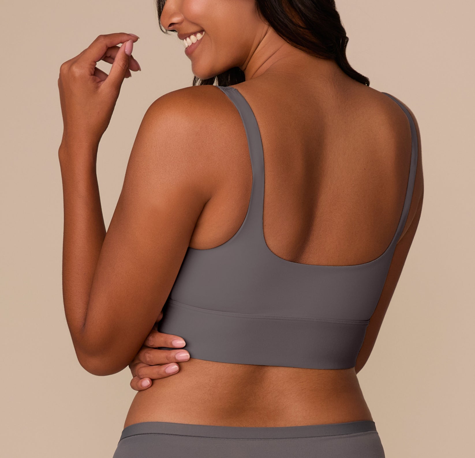 Back view of Victoria in the Bliss Square Neck Bralette in Smoke, showcasing the wide scoop back and soft microfiber fabric for a smooth finish.