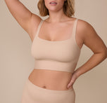 Sonnie wears the Bliss Square Neck Bralette in Beige, showing off its flattering square neckline and longline design. The smooth, seamless fabric fits comfortably against her skin. sizing: Sonnie wears size XL