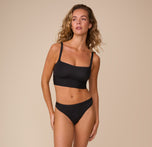 Freya pairs the Bliss Square Neck Bralette in Black with the matching Bliss Thong in Black, highlighting the coordinated, minimalistic look.