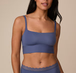 Close-up of Nemesis wearing the Bliss Square Neck Bralette in Twilight. The bralette features a wide square neckline and thick straps, offering both style and support. sizing: Nemesis wears size Medium