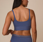 Back view of Nemesis in the Bliss Square Neck Bralette in Twilight. The wide back band and scoop back design highlight a smooth, comfortable fit.
