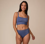 Full-body image of Nemesis wearing the Bliss Square Neck Bralette and matching Bliss Lace Highwaist Thong in Twilight. She stands confidently, showing the bralette’s flattering square neckline and fit.