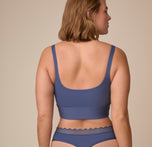 Back view of Sonnie in the Bliss Square Neck Bralette in Twilight. The bralette's wide back and square-cut design are shown from behind.