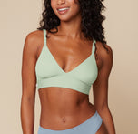 Front view of Ally wearing the Bliss Triangle Bralette in Dew. The adjustable straps and plunging neckline emphasize the smooth, wire-free design. sizing: Ally wears size XS